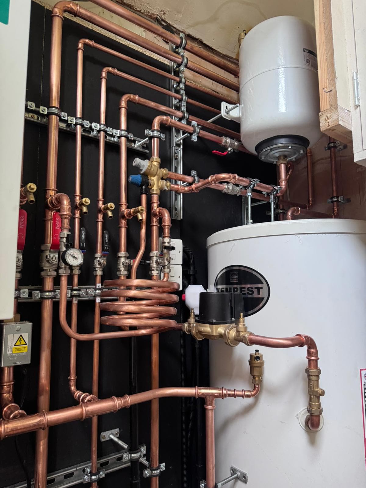 Tempest cylinder with expansion vessel and coiled copper pipework detail